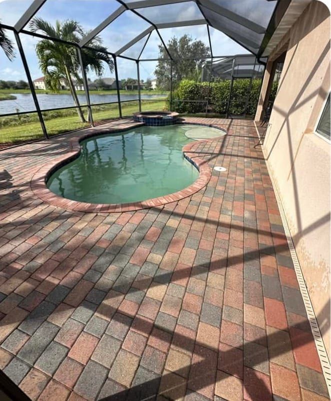 After: the same pool deck pressure washed and re-sanded, cleaned but deliberately not sealed, in Southwest Florida — Gulf Coast Sealing & Pressure Cleaning