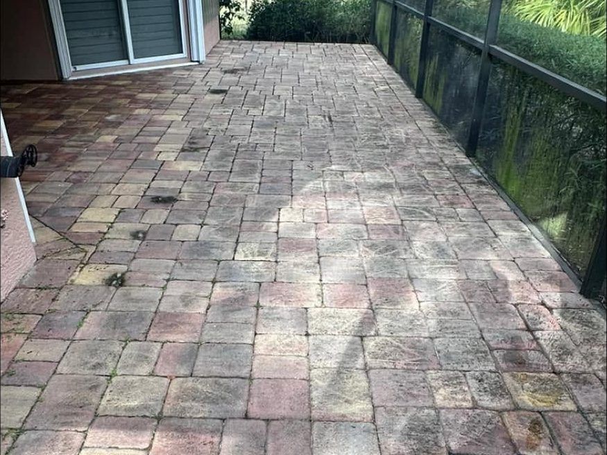 Before: faded, mildewed lanai pavers before cleaning and sealing in Naples, FL — Gulf Coast Sealing & Pressure Cleaning
