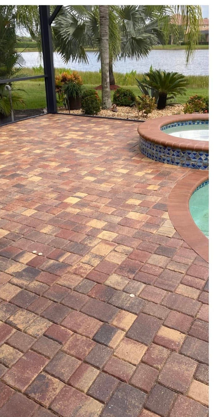 After: the same pool deck cleaned, re-sanded and sealed to a rich red and tan finish in Southwest Florida — Gulf Coast Sealing & Pressure Cleaning