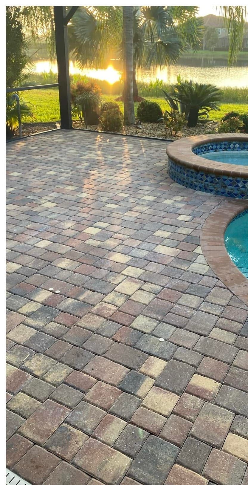 Before: a dull, weathered paver pool deck and spa surround in Southwest Florida — Gulf Coast Sealing & Pressure Cleaning