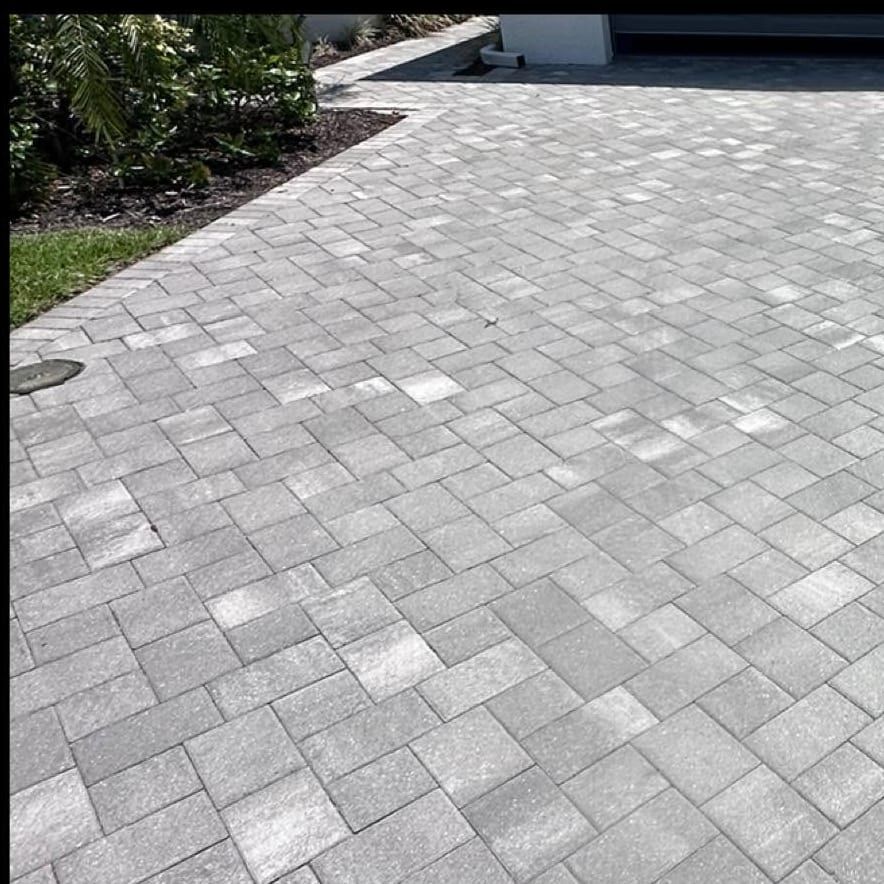 Finished grey paver driveway after cleaning, re-sanding and sealing in Bonita Springs, FL — Gulf Coast Sealing & Pressure Cleaning