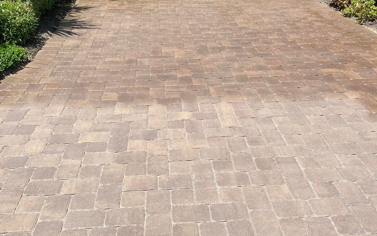 Freshly sealed brown paver driveway with a satin wet-look finish in Bonita Springs, FL — Gulf Coast Sealing & Pressure Cleaning