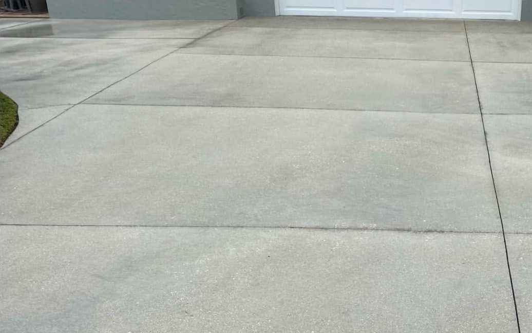 Concrete driveway pressure washed clean of mildew and grime in Bonita Springs, FL — Gulf Coast Sealing & Pressure Cleaning