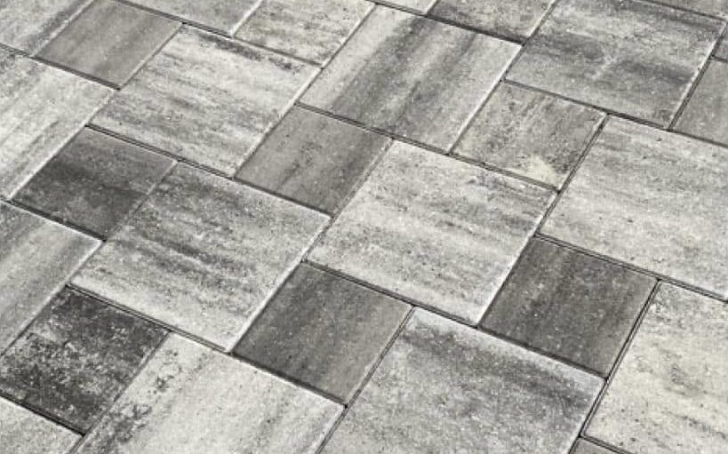 Paver driveway after pressure washing removed hydraulic fluid stains in Bonita Springs, FL — Gulf Coast Sealing & Pressure Cleaning