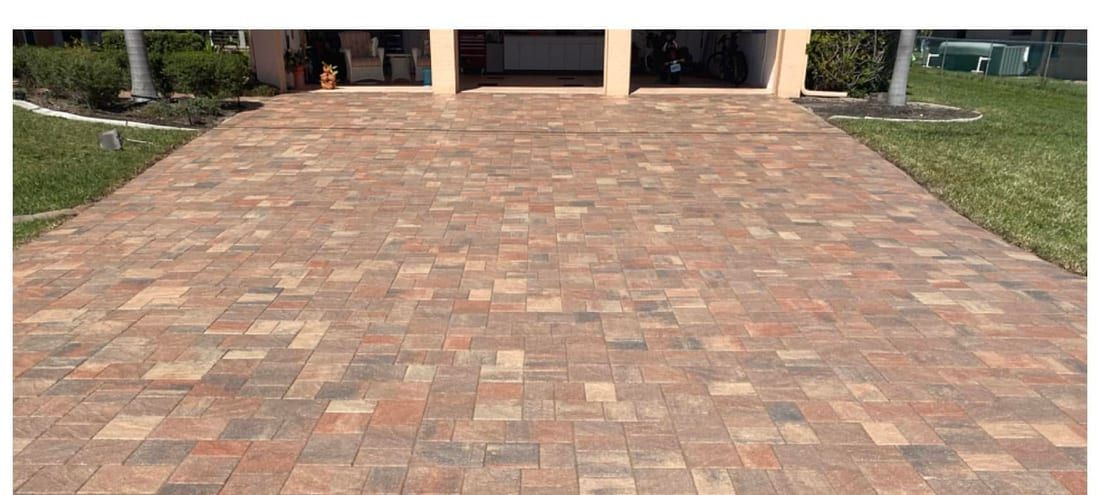 Paver driveway restored to an even red-brown after the old failed sealer was stripped off, in Southwest Florida — Gulf Coast Sealing & Pressure Cleaning